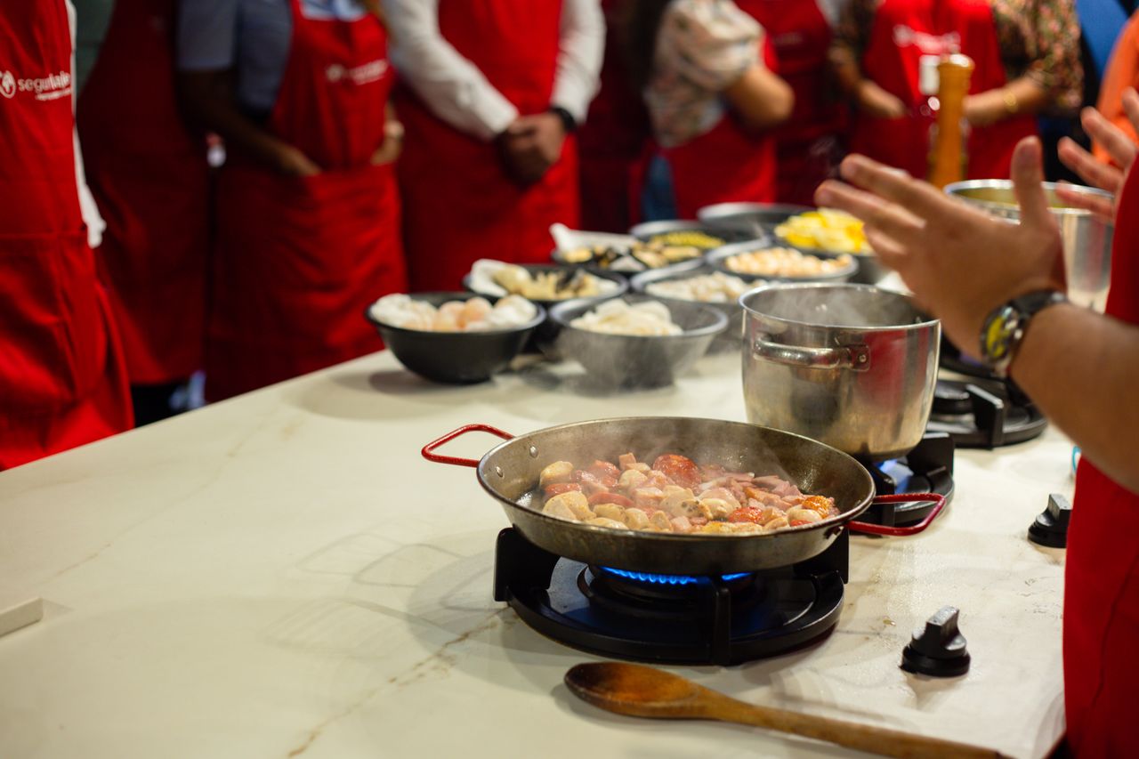 Crafting Captivating Headlines: Your awesome post title goes here Participants learn cooking skills in a vibrant class setting, engaging with hands-on food preparation.